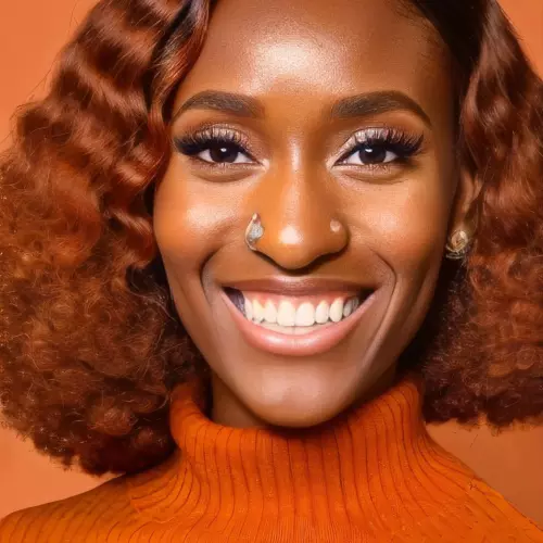 Yvonne Ile, smiling, with an orange background